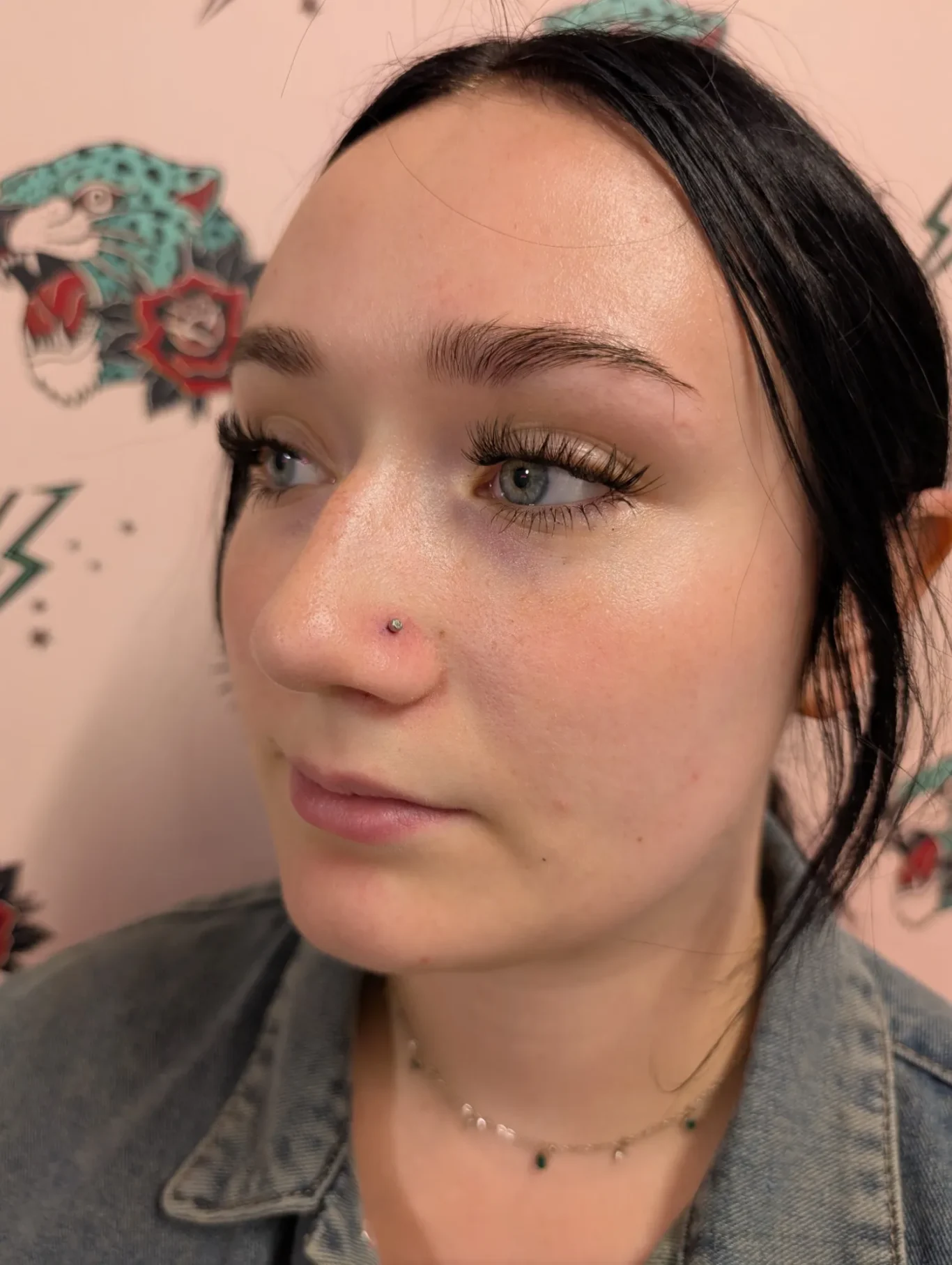 Nostril Piercing Side view of a woman's face with simple single nostril piercing.