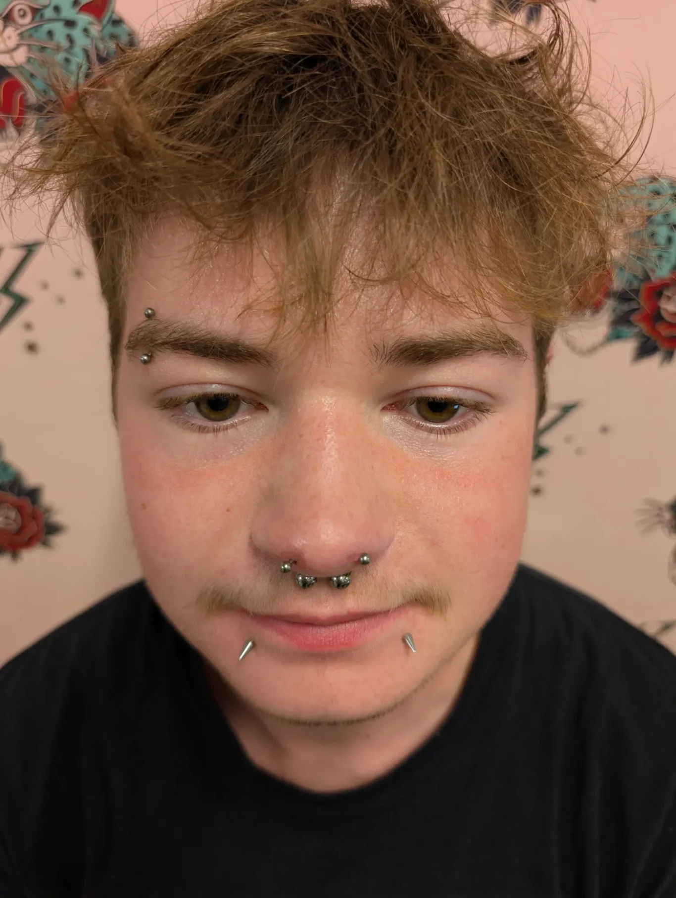 Forward Facing Nostril Piercings Close up view of a man's face, showing a set of forward facing nostril piercings.