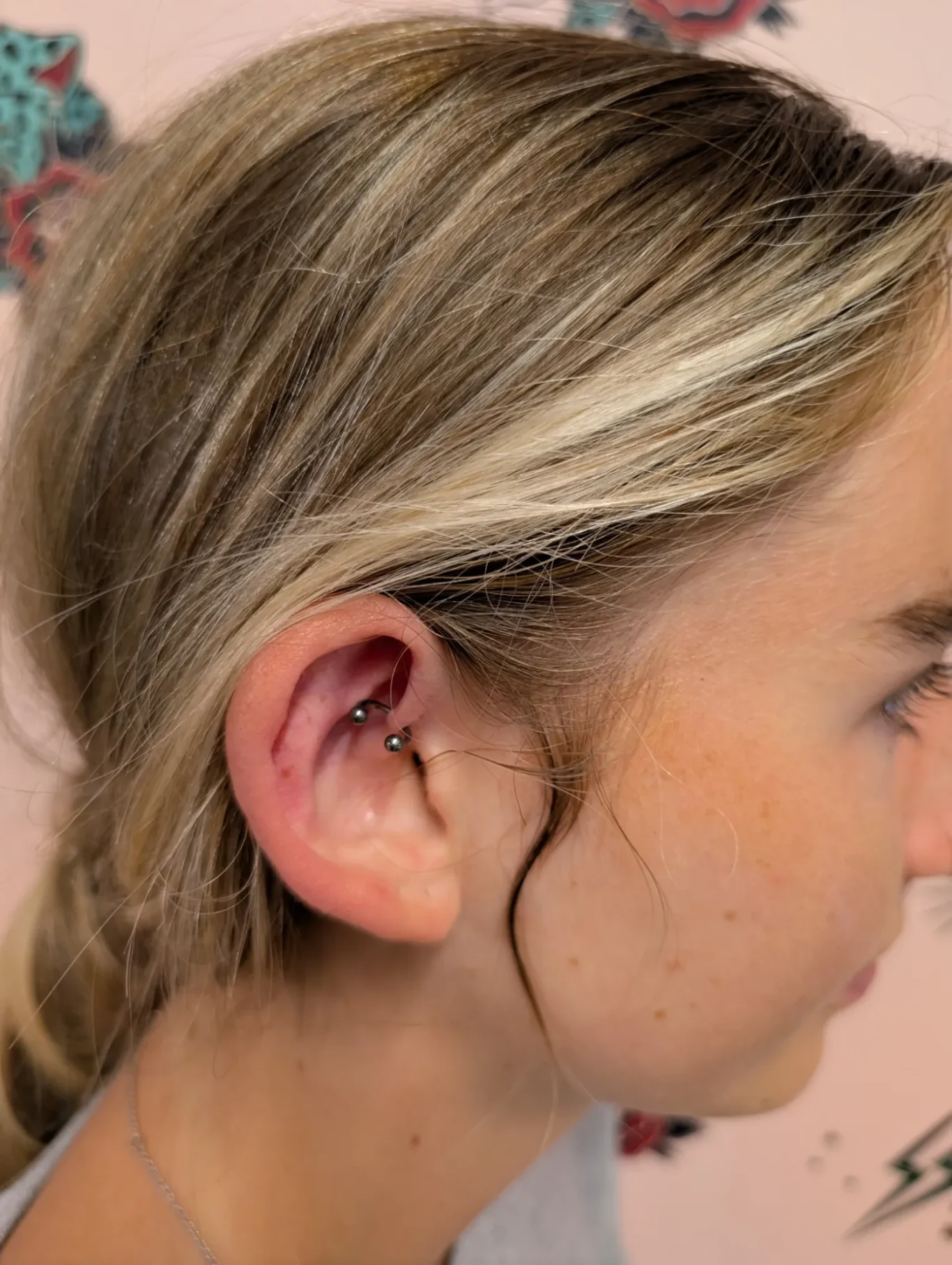 Daith Ear Piercing Side view of a woman with a freshly pierced daith ear piercing.