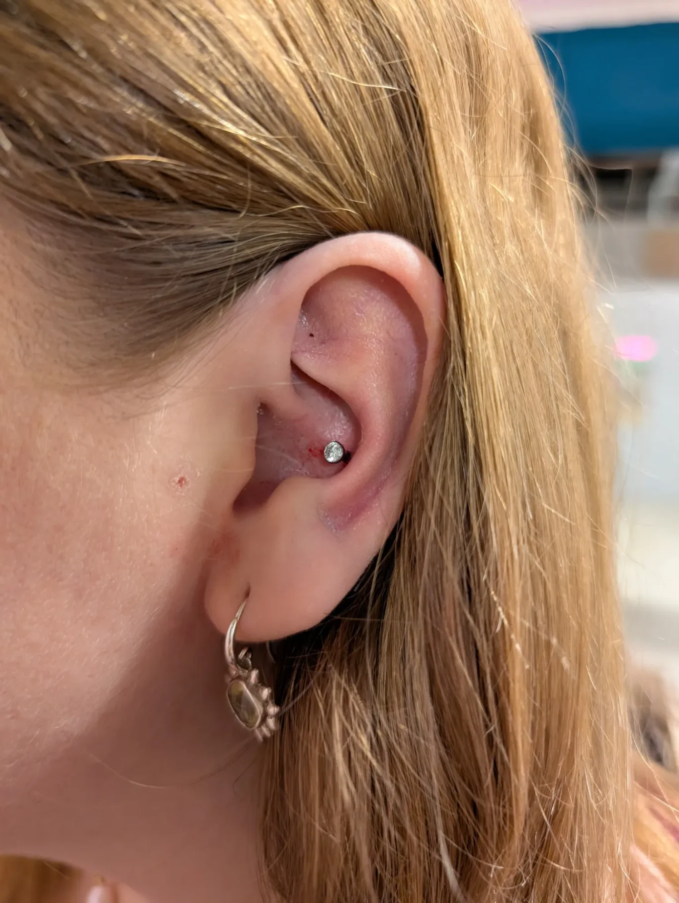 Conch Ear Piercing Close up of a conch ear piercing with simple gem jewellery.