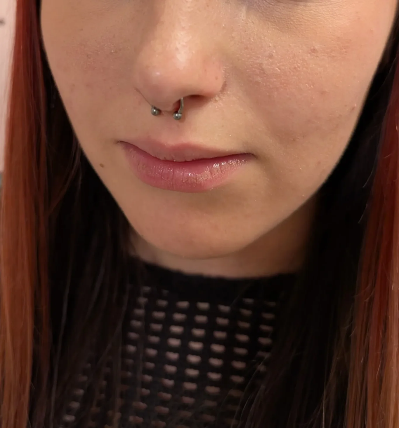 Septum Piercing Close up shot of a woman's face showing a freshly done septum piercing.